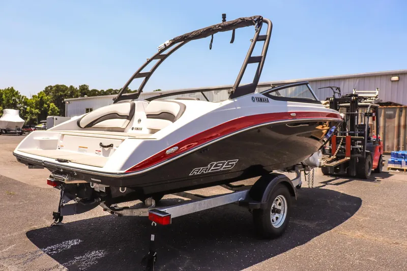Slide: The Image of 2025 Yamaha Boats AR195 on trailer, sleek design, parked outdoors. - 4