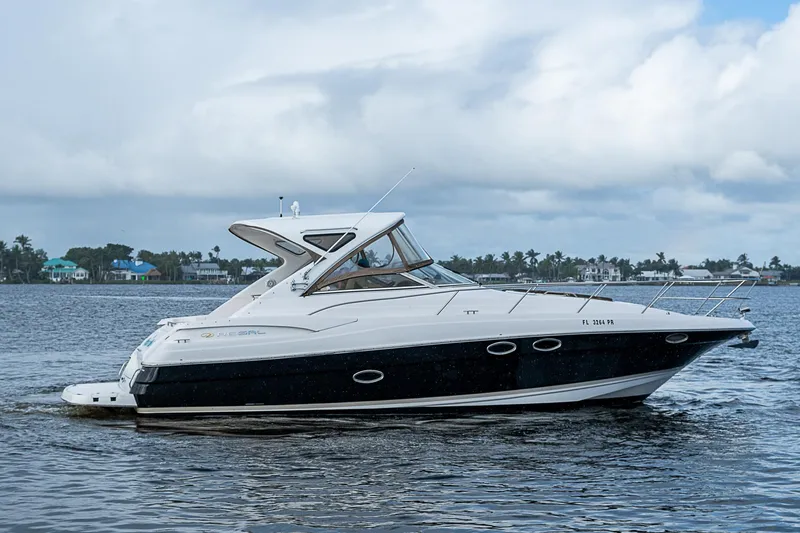 Slide: The Image of 2008 Regal Commodore 3760 IB yacht on calm water under cloudy sky. - 11