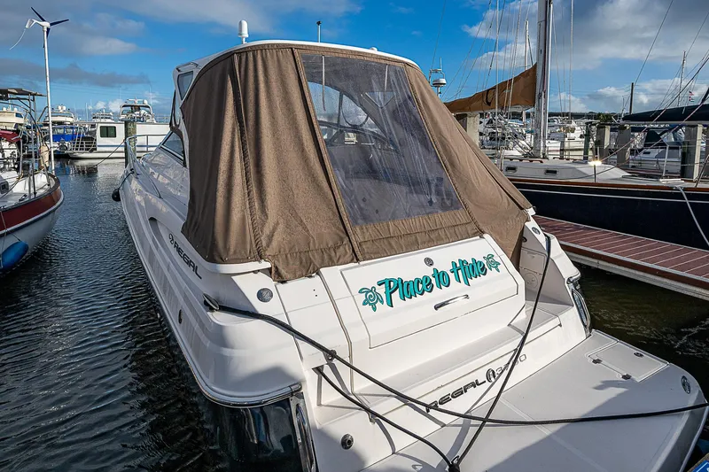 Slide: The Image of 2008 Regal Commodore 3760 IB yacht docked at marina, brown canopy, clear sky. - 14