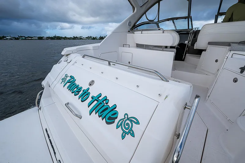 Slide: The Image of 2008 Regal Commodore 3760 IB boat with "A Place to Hide" text on the stern. - 15