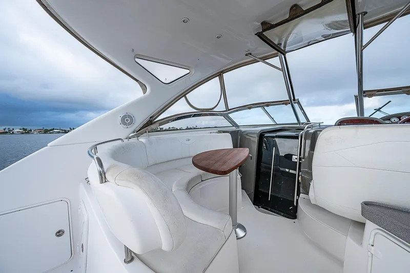 Slide: The Image of 2008 Regal Commodore 3760 IB yacht interior with white seating and wooden table. - 17