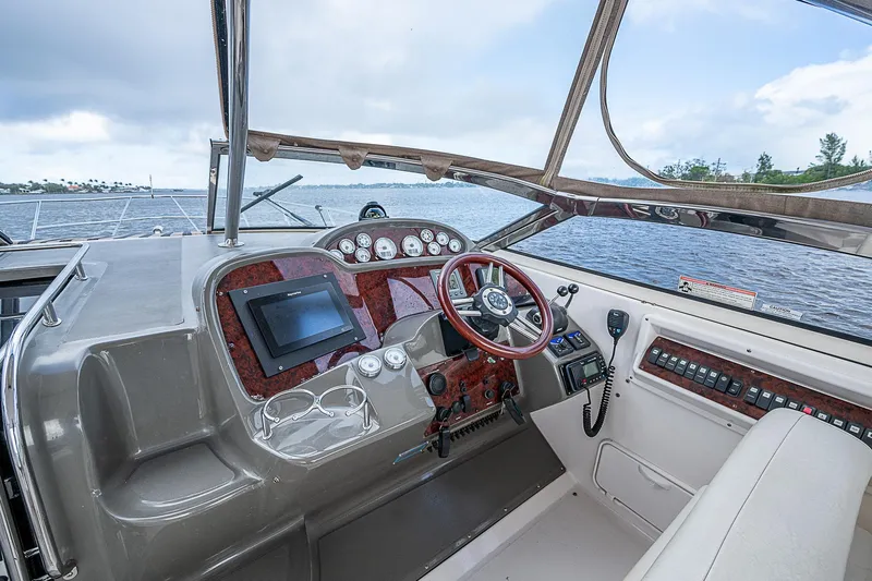 Slide: The Image of 2008 Regal Commodore 3760 IB helm with modern controls and scenic water view. - 18