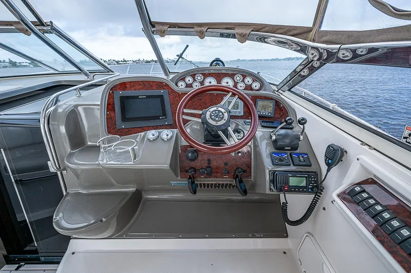 Slide: The Image of 2008 Regal Commodore 3760 IB boat cockpit with steering wheel and navigation controls. - 19