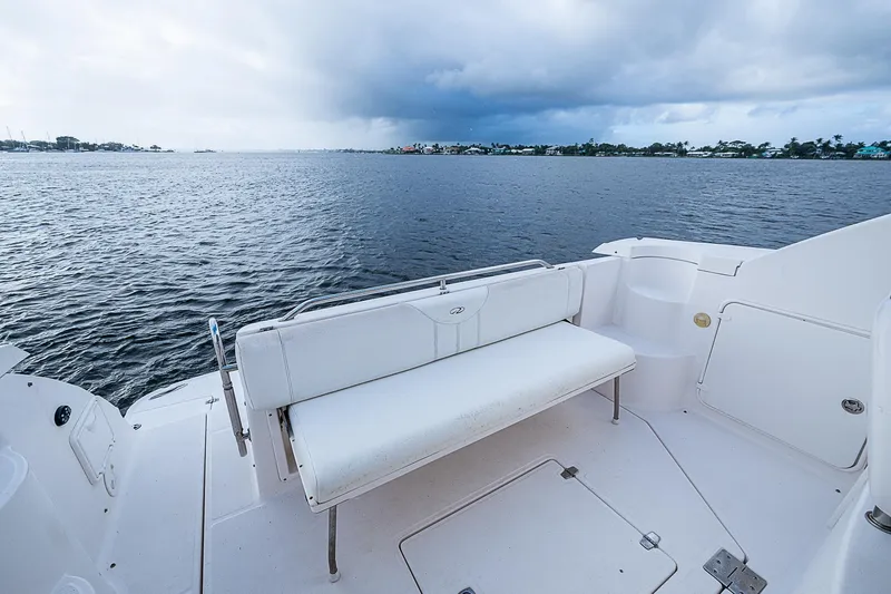 Slide: The Image of 2008 Regal Commodore 3760 IB boat with white seating, overlooking calm waters. - 22