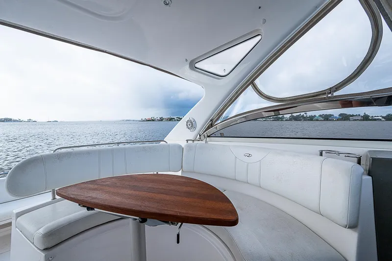 Slide: The Image of Luxurious 2008 Regal Commodore 3760 IB yacht interior with elegant seating and wooden table. - 25