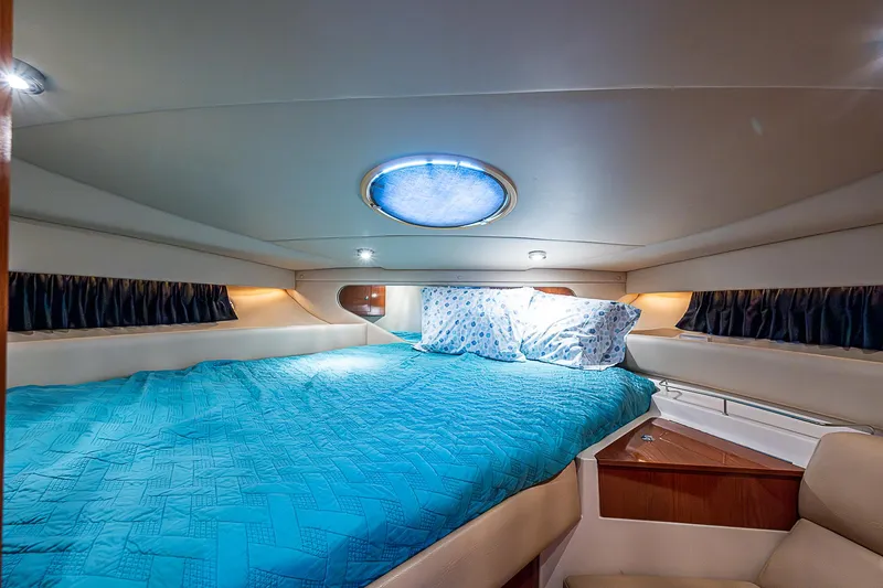 Slide: The Image of Luxurious cabin interior of 2008 Regal Commodore 3760 IB yacht with blue bedding. - 32