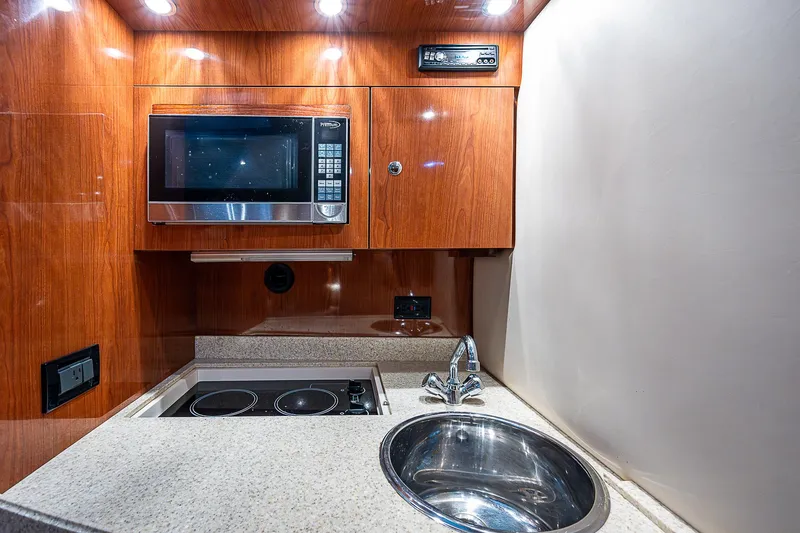 Slide: The Image of 2008 Regal Commodore 3760 IB yacht kitchen with microwave, stove, and sink. - 39
