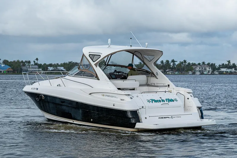 Slide: The Image of 2008 Regal Commodore 3760 IB yacht cruising on a calm lake. - 7