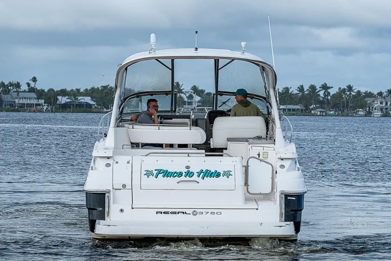 Slide: The Image of 2008 Regal Commodore 3760 IB boat cruising on a calm waterway. - 8