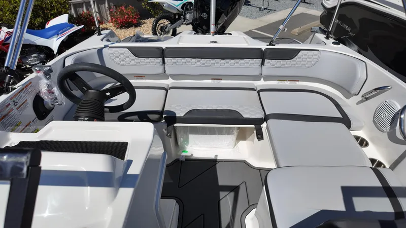 Slide: The Image of 2025 Bayliner M17 boat interior with modern seating and steering wheel. - 10