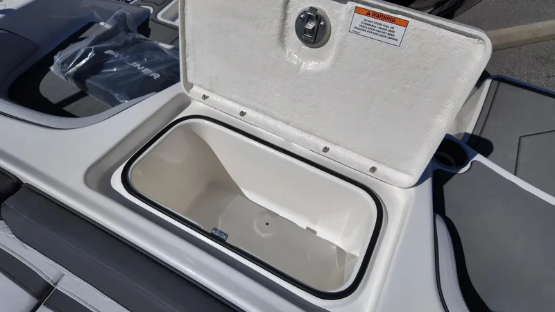 Slide: The Image of Open storage compartment on 2025 Bayliner M17 boat, showcasing interior space. - 7