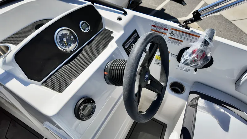 Slide: The Image of 2025 Bayliner M17 boat dashboard with steering wheel and gauges. - 9
