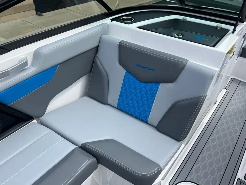 Slide: The Image of 2024 MasterCraft XT20 boat interior with gray and blue seating. - 10