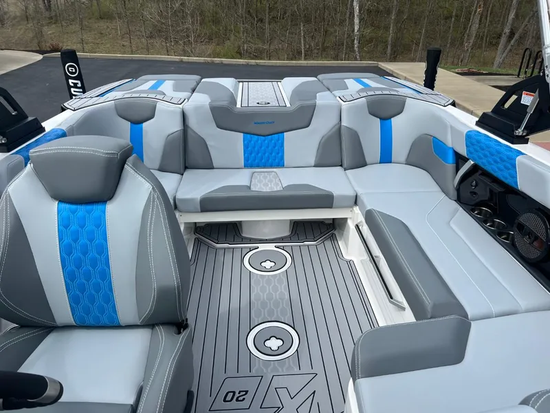 Slide: The Image of 2024 MasterCraft XT20 boat interior with gray and blue seating, modern design. - 11