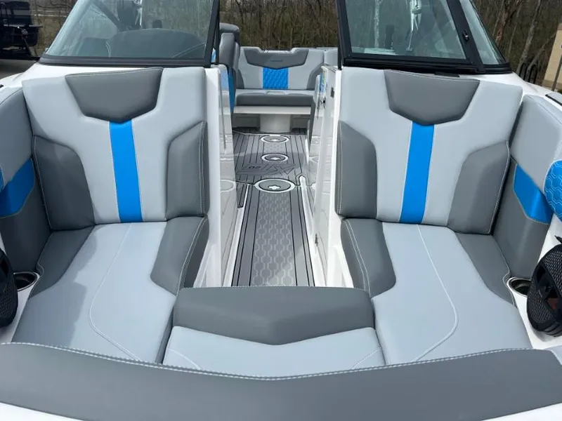 Slide: The Image of 2024 MasterCraft XT20 boat interior with gray and blue seating, modern design. - 7