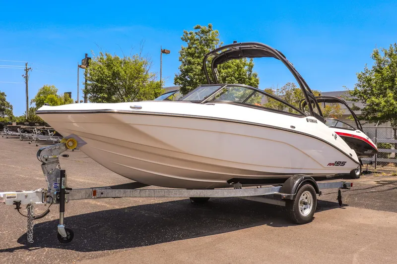 The Image of 2025 Yamaha Boats AR195 on trailer, sleek design, parked outdoors. - 0