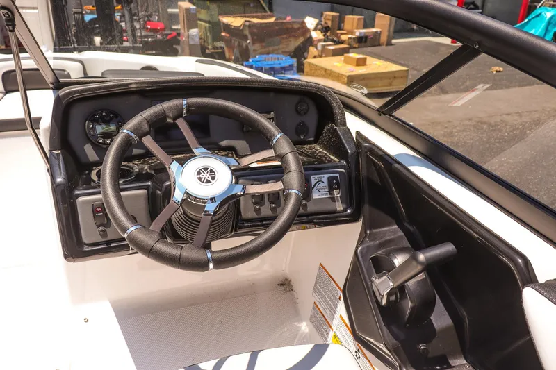 Slide: The Image of 2025 Yamaha Boats AR195 steering wheel and dashboard in a sunlit setting. - 11