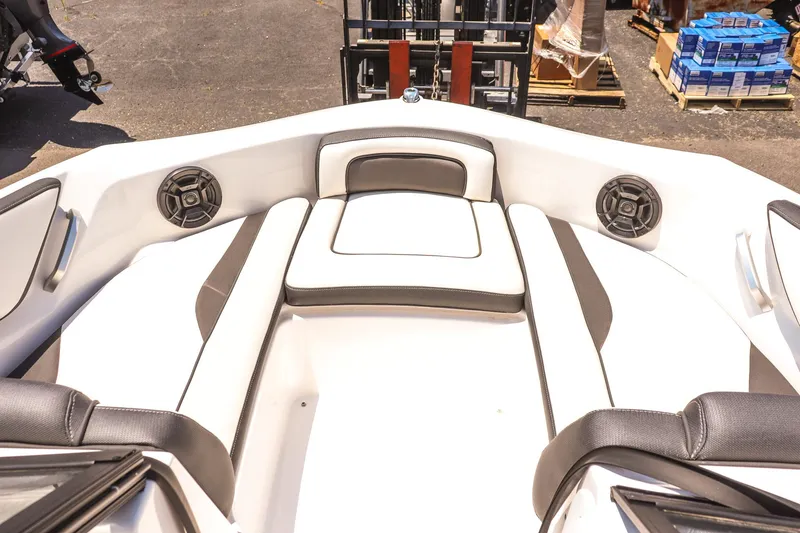 Slide: The Image of 2025 Yamaha Boats AR195 interior with white and black seating and built-in speakers. - 13