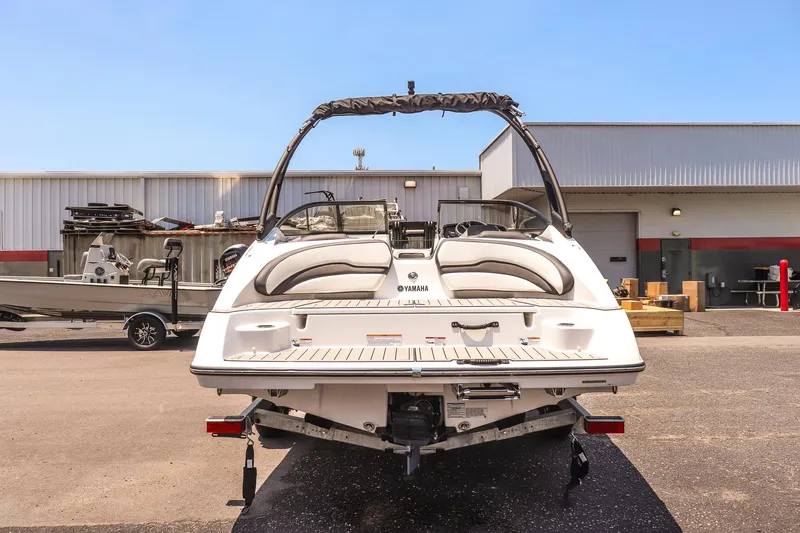 Slide: The Image of 2025 Yamaha AR195 boat rear view in a marina setting. - 3