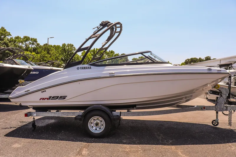 Slide: The Image of 2025 Yamaha Boats AR195 on trailer, sleek design, sunny day background. - 5