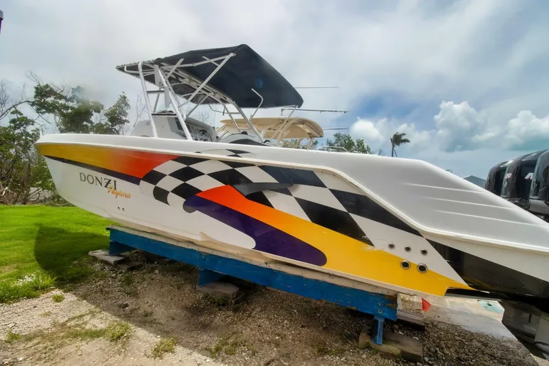 Slide: The Image of 2005 Donzi 35 ZF Cuddy boat with vibrant racing graphics on display. - 3