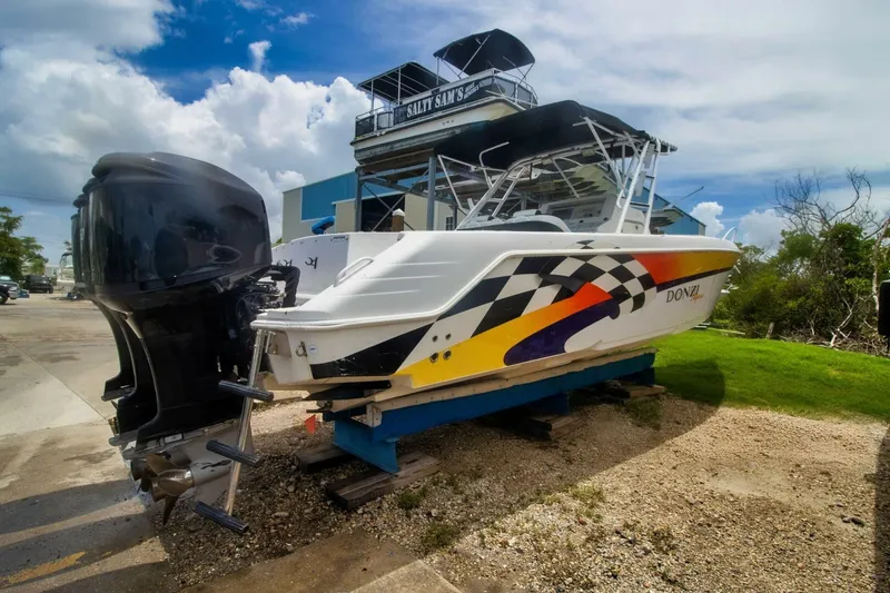 Slide: The Image of 2005 Donzi 35 ZF Cuddy boat with vibrant graphics on a trailer. - 5