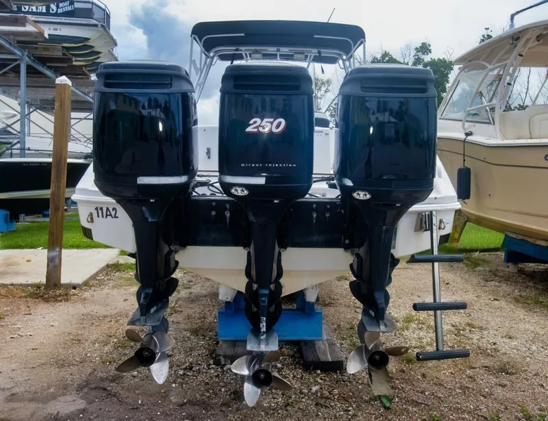 Slide: The Image of 2005 Donzi 35 ZF Cuddy with triple 250 horsepower outboard engines, docked on land. - 7