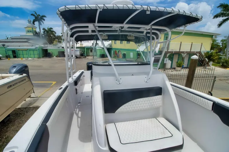 Slide: The Image of 2005 Donzi 35 ZF Cuddy boat with seating, docked in a marina. - 9