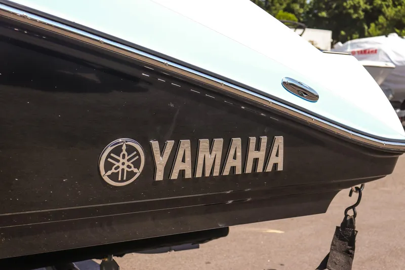 Slide: The Image of 2025 Yamaha Boats 195S, close-up of logo on sleek black hull. - 10