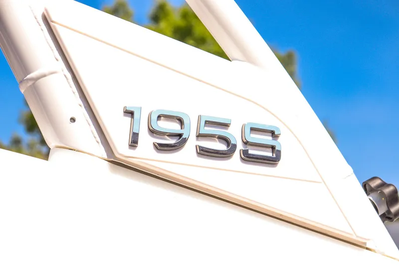 Slide: The Image of 2025 Yamaha Boats 195S logo on sleek white surface, set against a clear blue sky. - 11