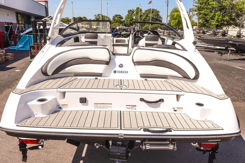 Slide: The Image of 2025 Yamaha Boats 195S, rear view, showcasing sleek design and spacious seating. - 12