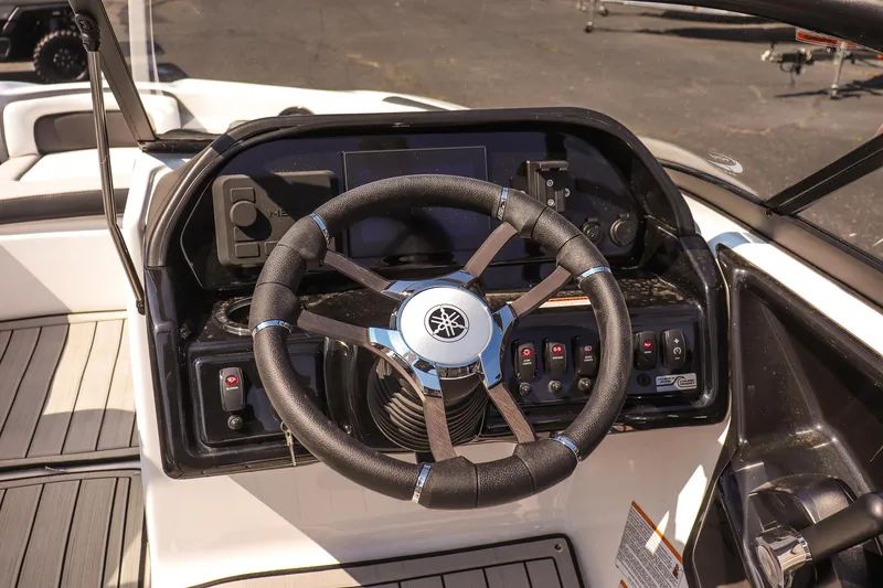 Slide: The Image of 2025 Yamaha Boats 195S steering wheel and dashboard, featuring modern controls and sleek design. - 14