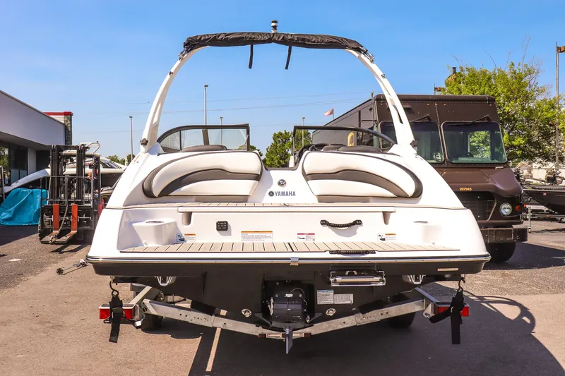 Slide: The Image of 2025 Yamaha Boats 195S, rear view, parked outdoors on a sunny day. - 4