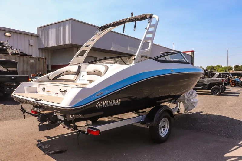 Slide: The Image of 2025 Yamaha Boats 195S on trailer, sleek design, parked outdoors. - 5