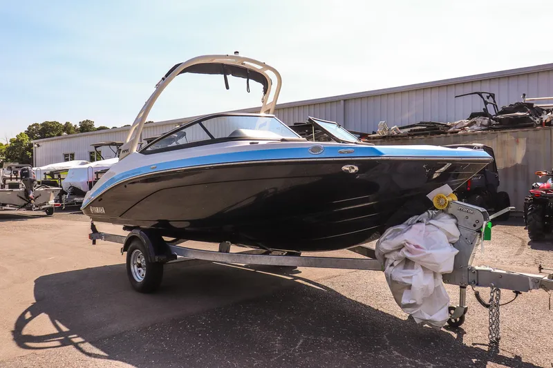 Slide: The Image of 2025 Yamaha Boats 195S on trailer, sleek design, parked outdoors. - 7