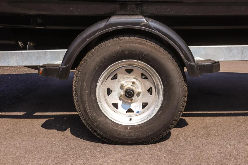 Slide: The Image of Trailer wheel of a 2025 Yamaha Boats 195S on asphalt. - 9