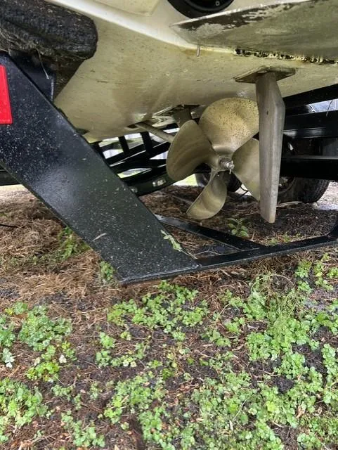 Slide: The Image of 2015 Tigé RZR boat propeller and trailer on grassy ground. - 10