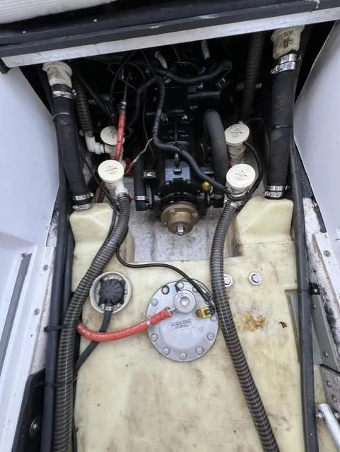 Slide: The Image of Engine compartment of a 2015 Tigé RZR boat with visible hoses and components. - 15