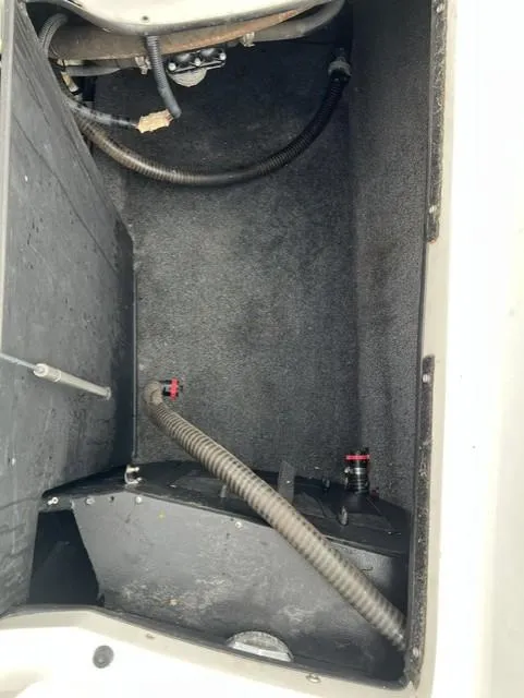 Slide: The Image of 2015 Tigé RZR boat storage compartment with hoses and fittings. - 16