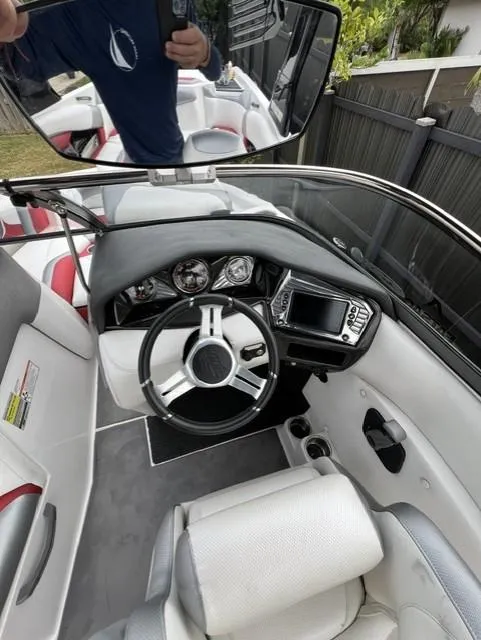 Slide: The Image of 2015 Tigé RZR boat interior with steering wheel, dashboard, and seating. - 17