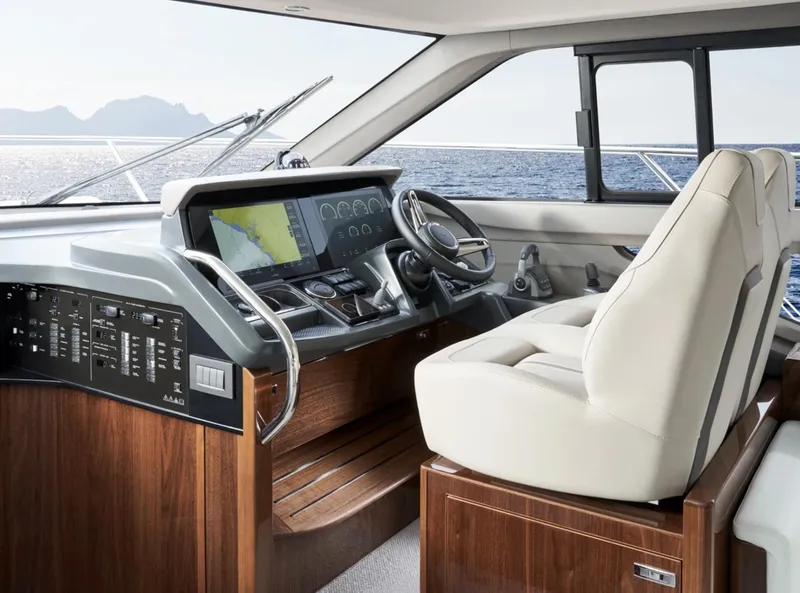 Slide: The Image of Luxurious 2025 Princess F50 yacht cockpit with modern navigation system and elegant wood finish. - 24