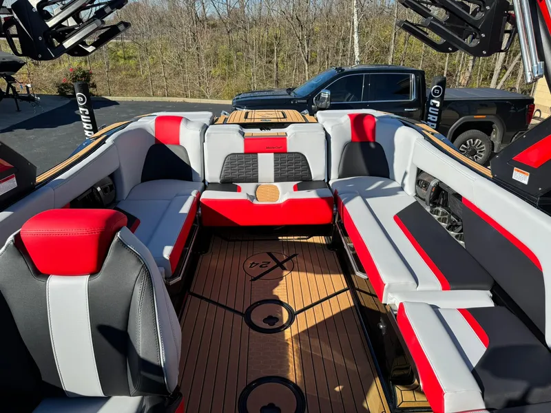 Slide: The Image of 2024 MasterCraft X24 boat interior with red, black, and gray seating. - 10