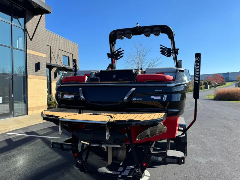 Slide: The Image of 2024 MasterCraft X24 boat rear view with wakeboard tower and swim platform. - 4