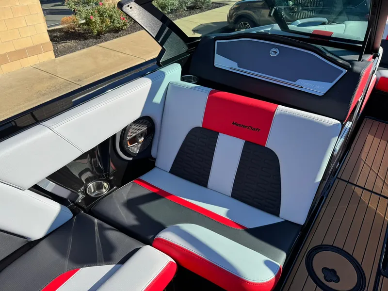 Slide: The Image of 2024 MasterCraft X24 boat interior with red, black, and white seating. - 9