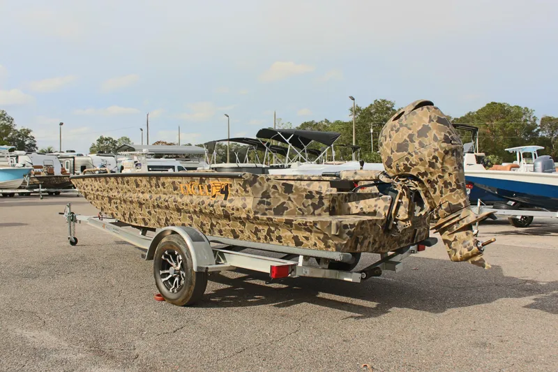 Slide: The Image of 2025 Excel 1860 Viper F4 CC boat with camouflage design on a trailer. - 10