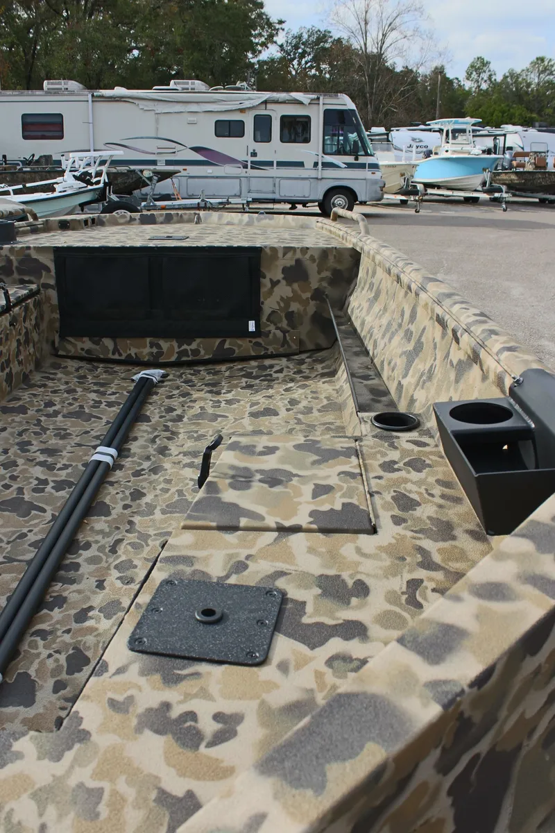 Slide: The Image of 2025 Excel 1860 Viper F4 CC boat with camouflage interior, parked outdoors. - 13