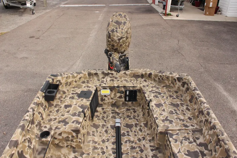 Slide: The Image of 2025 Excel 1860 Viper F4 CC boat with camouflage interior, parked on pavement. - 25