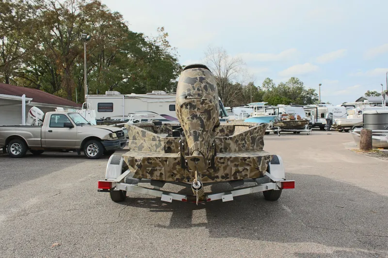 Slide: The Image of 2025 Excel 1860 Viper F4 CC boat with camouflage design on a trailer in a parking lot. - 9
