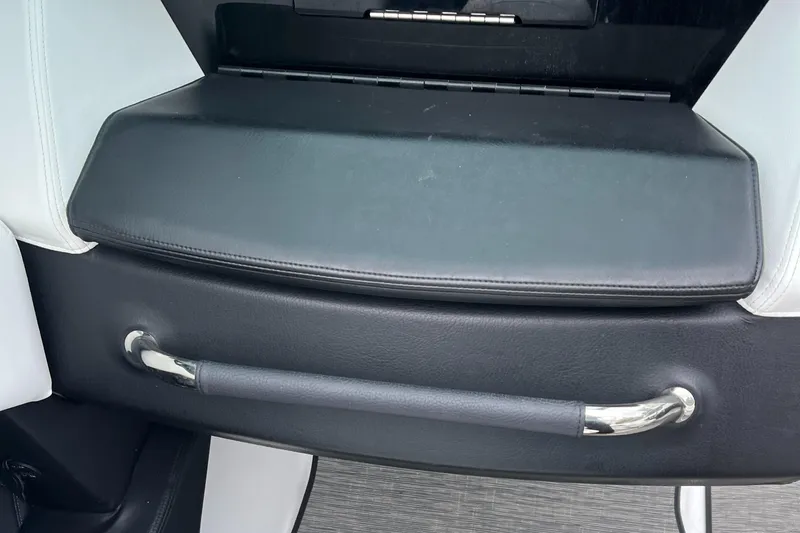 Slide: The Image of 2022 Four Winns H4 OB boat interior with sleek black and white seating and chrome handle. - 13