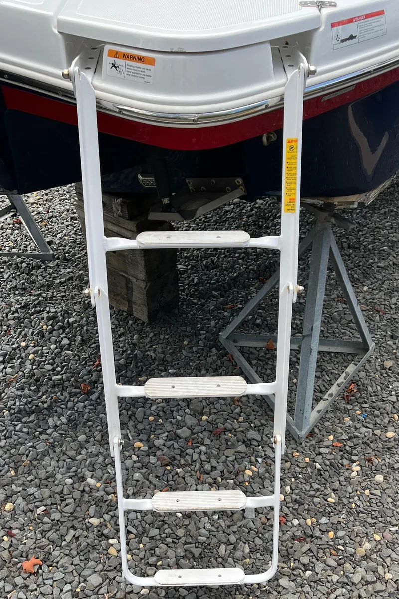 Slide: The Image of Four Winns H4 OB 2022 boat ladder on gravel surface. - 6